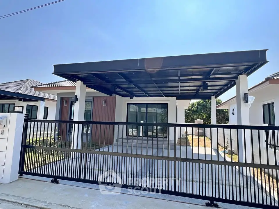 Modern single-story house with spacious carport and gated entrance