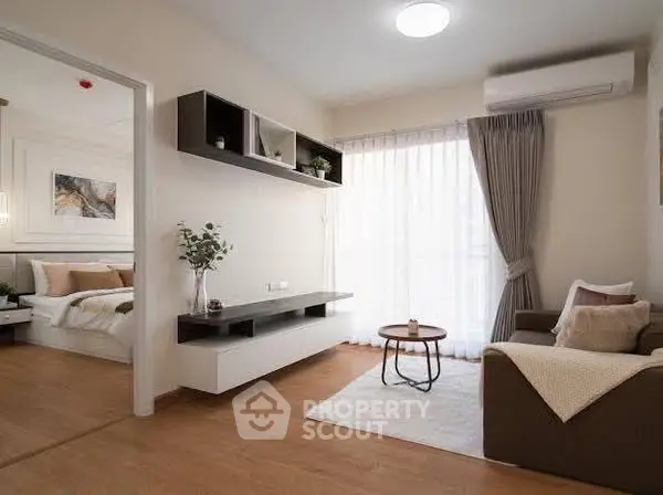 Modern living room with cozy seating and natural light, adjacent to stylish bedroom.