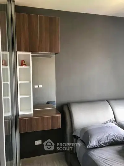 Modern bedroom with sleek design and stylish furniture, featuring a cozy bed and built-in storage solutions.