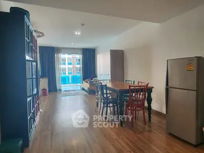 Spacious living room with dining area and modern furniture in a stylish apartment.