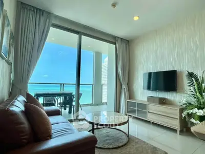 Luxurious living room with ocean view and modern furnishings in beachfront property.