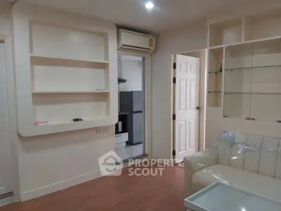 Cozy living room with built-in shelves and air conditioning in modern apartment