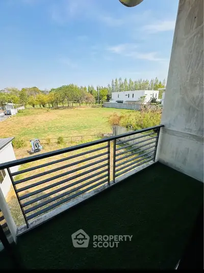 Charming balcony with lush green view in modern residential area