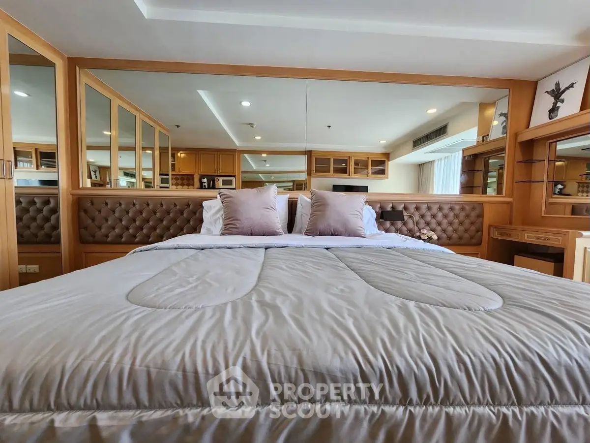 Luxurious bedroom with plush bedding and elegant wooden accents