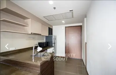 Modern kitchen with sleek countertops and built-in appliances in a contemporary apartment.