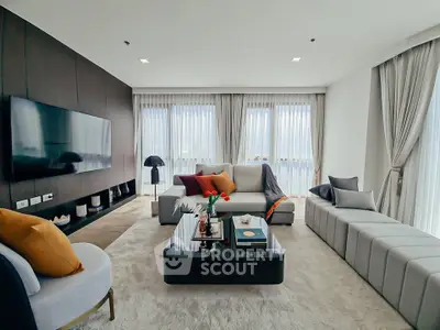 Luxurious modern living room with elegant decor and large windows.