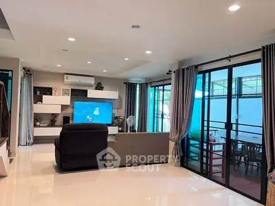Spacious modern living room with large windows and stylish decor