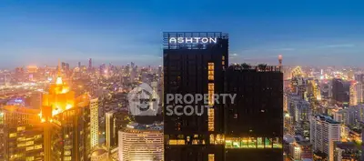 Stunning cityscape view with illuminated skyscrapers at dusk, highlighting a prominent modern building.