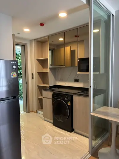Modern kitchen with sleek appliances and open layout in a stylish apartment
