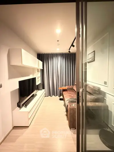 Modern living room with sleek furniture and floor-to-ceiling curtains, perfect for cozy evenings.