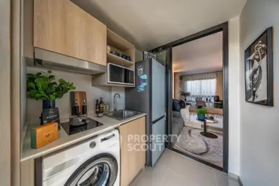 Modern compact kitchen with washing machine and open layout to living room