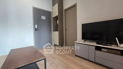 Modern living room with sleek TV setup and stylish wooden flooring