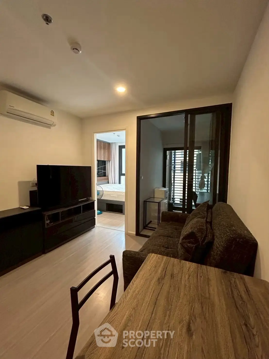 Modern living room with cozy seating and sleek TV setup