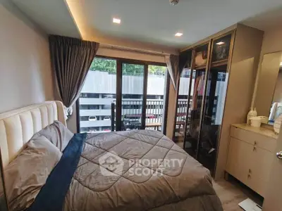 Modern bedroom with large window and stylish wardrobe in a cozy apartment.