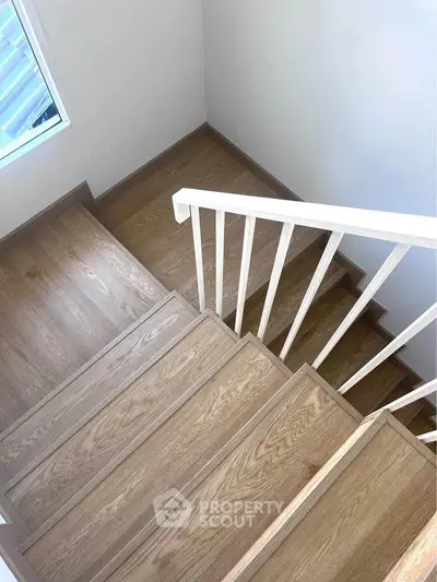 Elegant wooden staircase with natural light in modern home interior