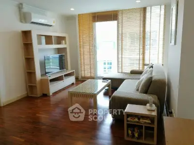 Spacious living room with modern furniture and large windows in a stylish apartment.