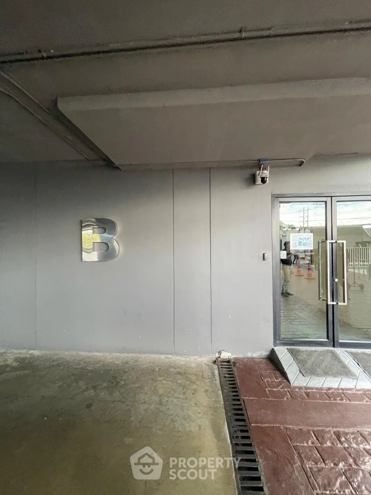 Modern building entrance with sleek design and security camera