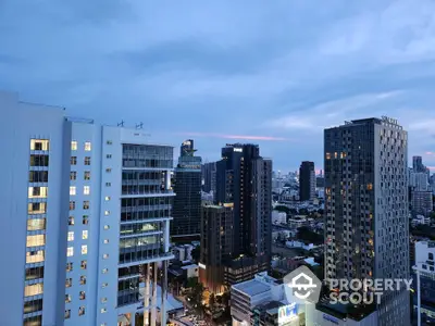 Stunning cityscape view from high-rise buildings at dusk, showcasing urban skyline and vibrant architecture.