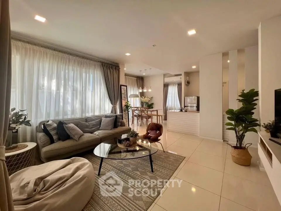 Spacious modern living room with elegant decor and open kitchen layout