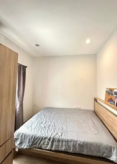 Cozy bedroom with wooden furniture and soft lighting, perfect for relaxation.