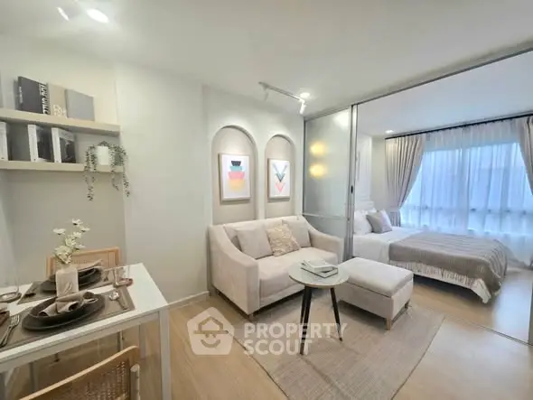 Modern open-plan living room and bedroom with elegant decor and natural light