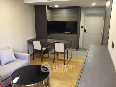 Modern studio apartment with sleek kitchen and cozy living area, perfect for urban living.