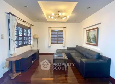 Elegant living room with modern lighting and stylish furniture in a cozy home setting.