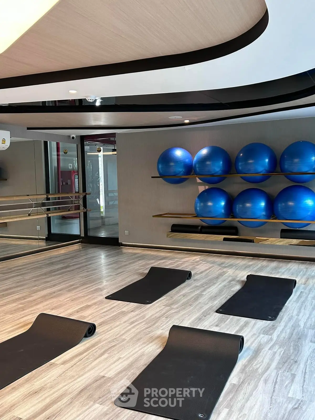 Modern gym with yoga mats and exercise balls in sleek interior design