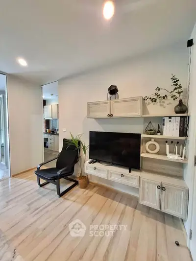 Modern living room with stylish decor and open kitchen view, perfect for cozy urban living.