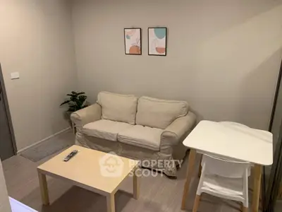 Cozy living room with beige sofa and modern decor, perfect for relaxation.