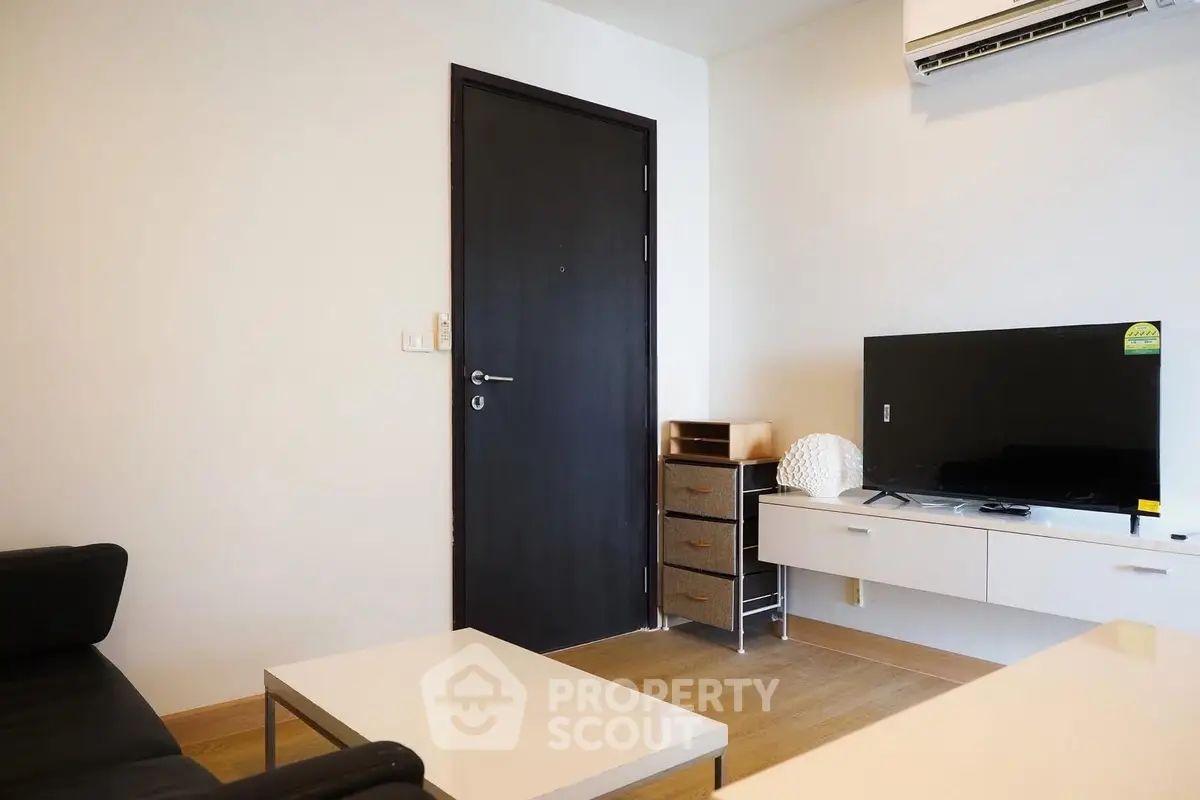 Modern living room with sleek furniture and flat-screen TV, perfect for urban living.