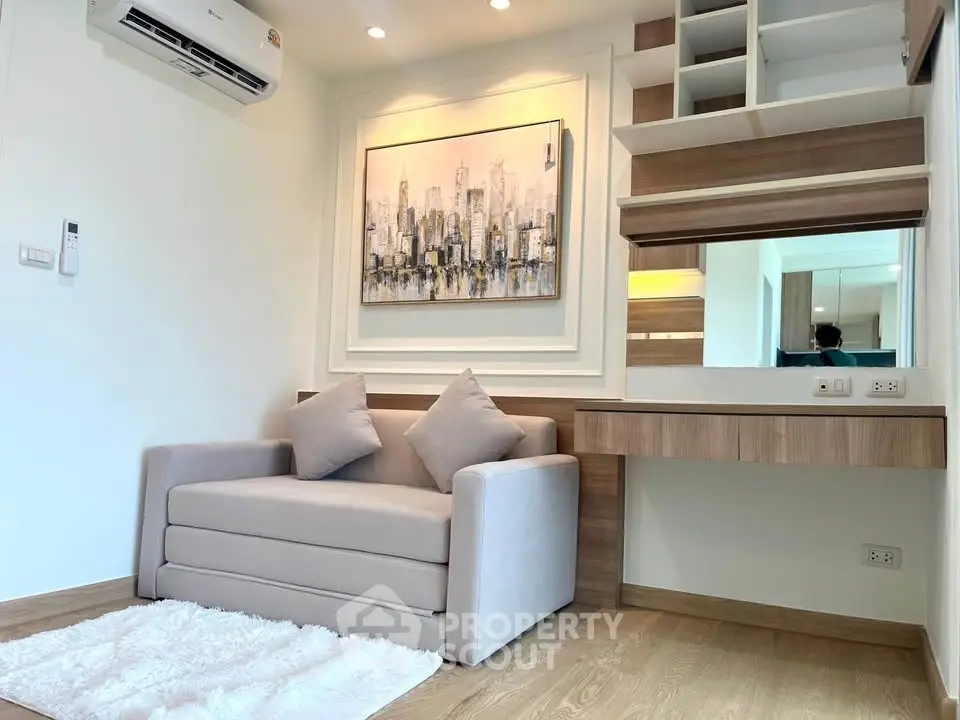 Modern living room with stylish sofa and wall art, featuring elegant wooden accents and cozy ambiance.