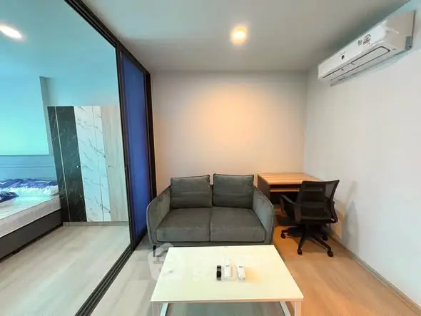 Modern studio apartment with cozy living area and workspace