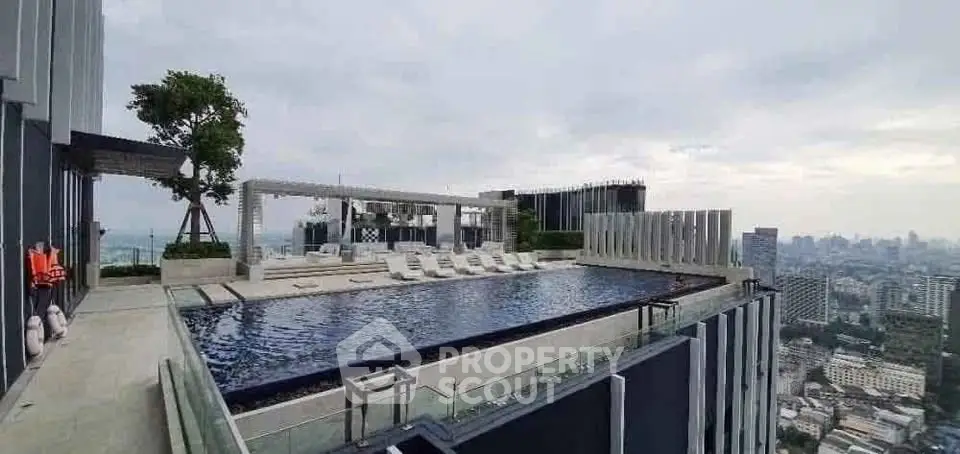 Luxurious rooftop pool with stunning cityscape views in modern high-rise building.