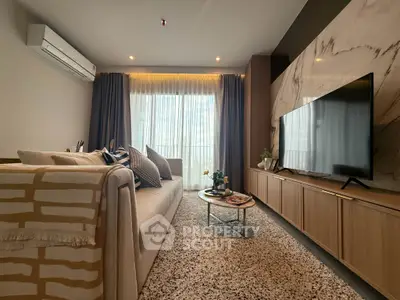 Stylish modern living room with elegant decor and large TV, perfect for relaxation and entertainment.