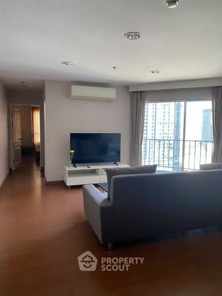 Spacious modern living room with city view and sleek furniture