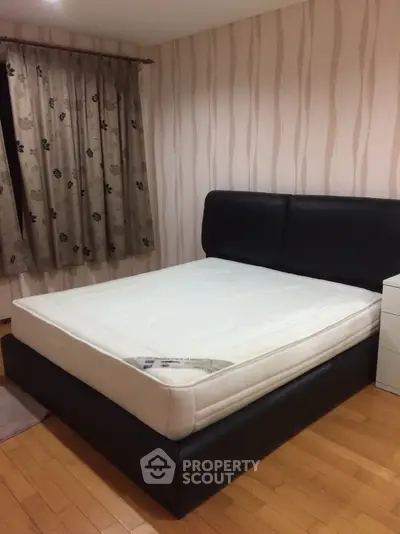 Cozy bedroom with stylish bed and elegant wallpaper, perfect for restful nights.