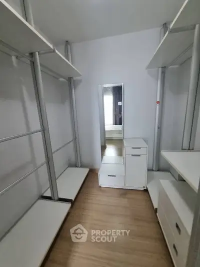Spacious walk-in closet with modern shelving and storage solutions.
