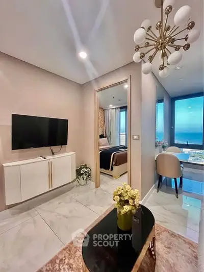 Modern living room with elegant decor and open view dining area in luxury apartment.