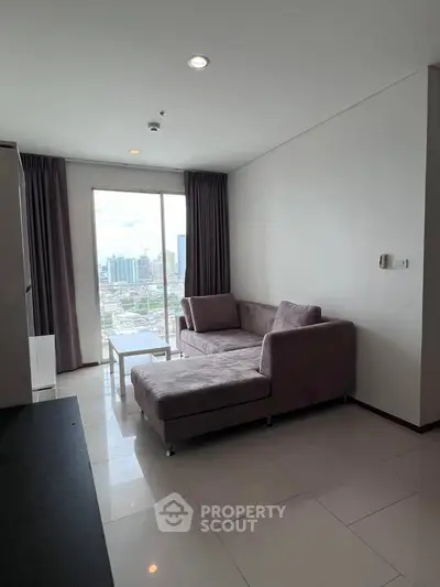 Modern living room with city view, featuring a stylish sofa and floor-to-ceiling windows.
