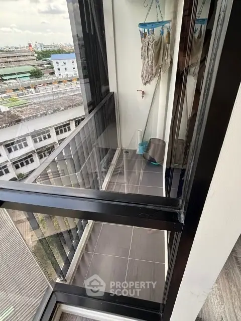 Compact balcony with city view, ideal for urban living and outdoor relaxation.