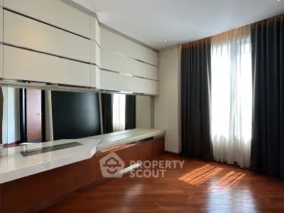 Spacious modern living room with hardwood floors and large window for natural light.