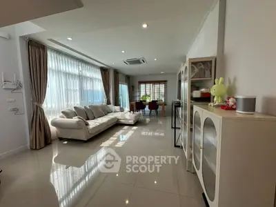 Spacious modern living room with large windows and elegant furnishings