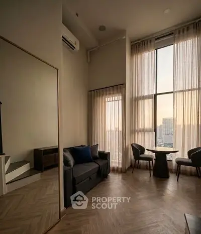 Luxurious high-ceiling living room with panoramic city view and elegant decor.