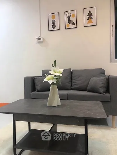 Modern living room with stylish gray sofa and elegant decor