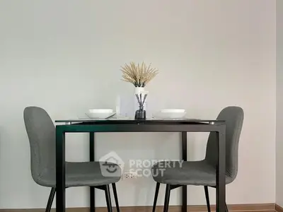 Modern dining area with sleek table and chairs, perfect for cozy meals.
