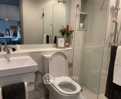Modern bathroom with sleek fixtures and glass shower enclosure