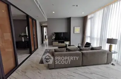 Luxurious modern living room with elegant decor and large windows