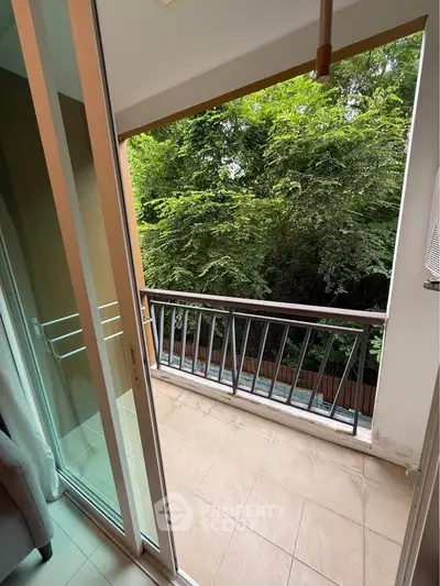 Charming balcony with lush green view, perfect for relaxation and enjoying nature.