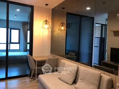 Modern living room with cozy sofa and stylish lighting in open-plan apartment